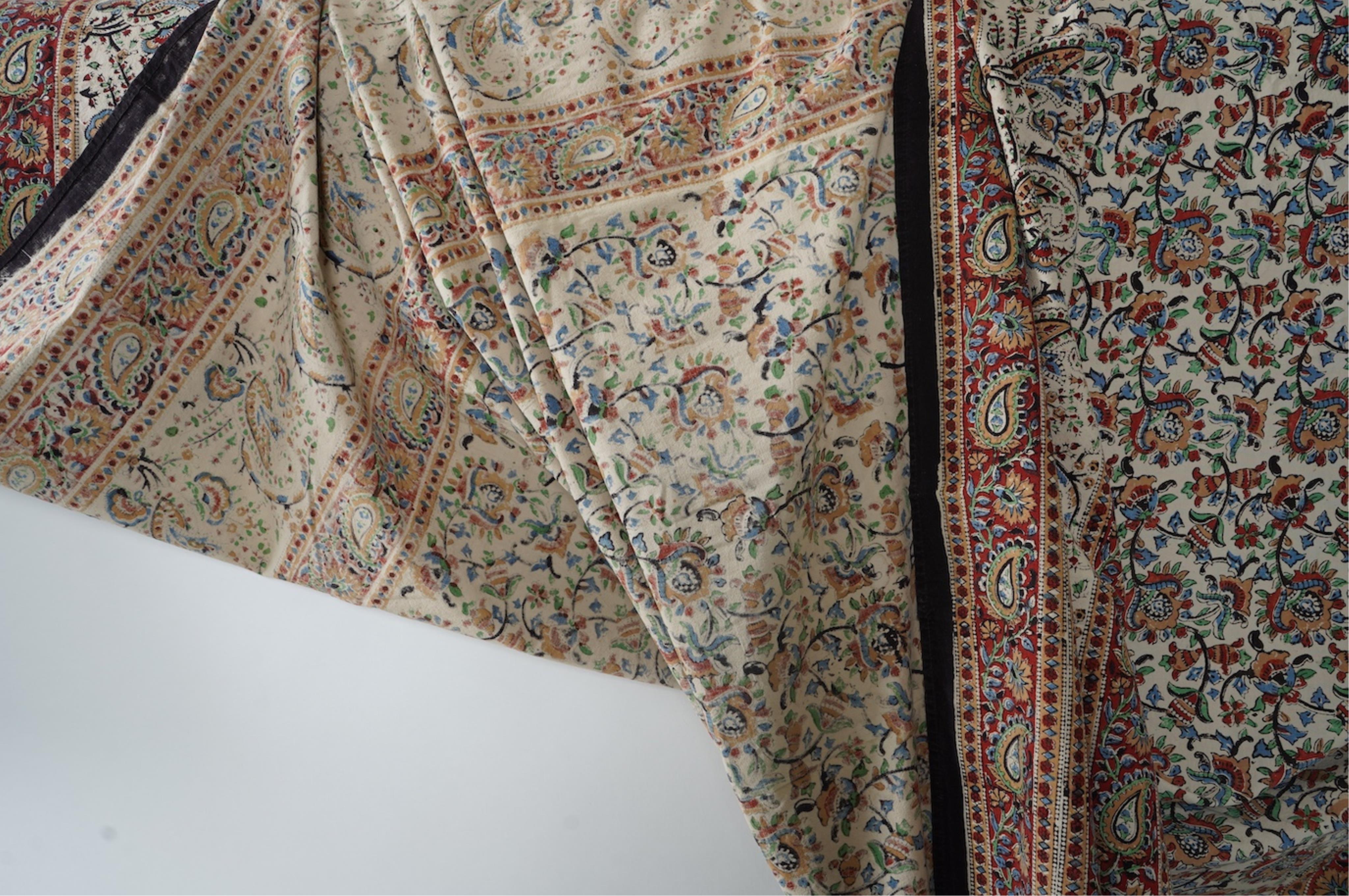 Two late 20th century large Indian block printed cotton bedcovers. One printed with brown borders, the other with brick red borders, both with large central panels designed in a classical Indian floral vining design. Bro